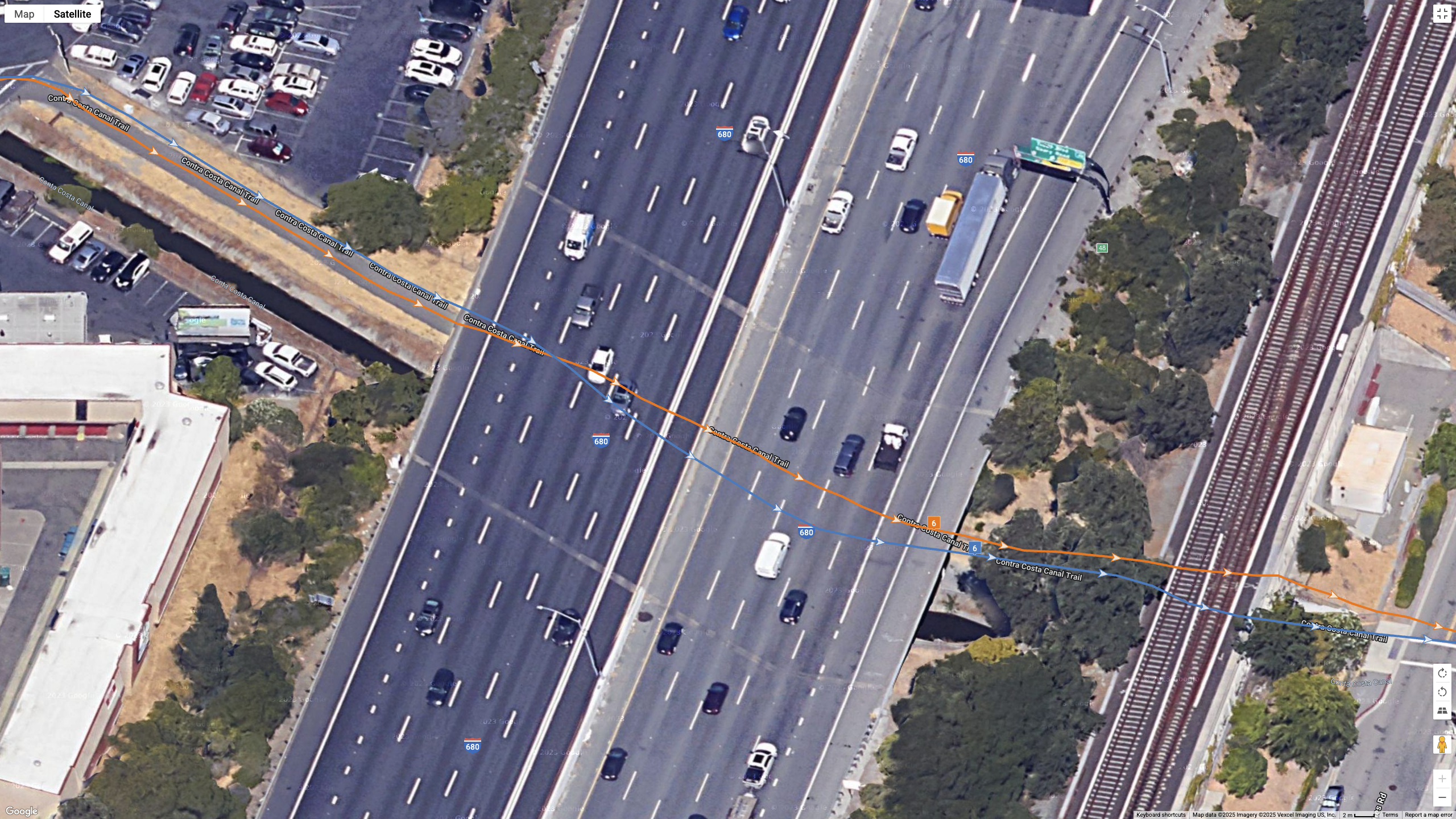 Μια δορυφορική εικόνα των Χαρτών Google που δείχνει πώς το COROS PACE 4 (μπλε γραμμή) συγκρίνεται με το Garmin Forerunner 970 (πορτοκαλί γραμμή) για ακρίβεια GPS διπλής συχνότητας για μια προαστιακή διαδρομή.