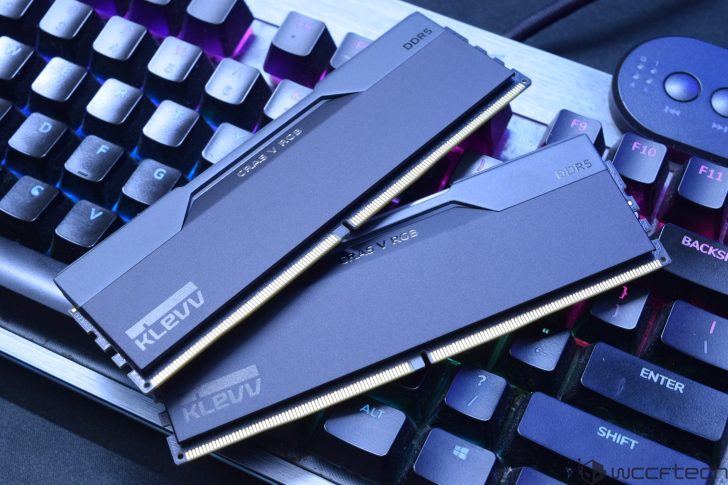 Two KLEVV CRAS V RGB DDR5 memory modules are placed on a colorful backlit keyboard.