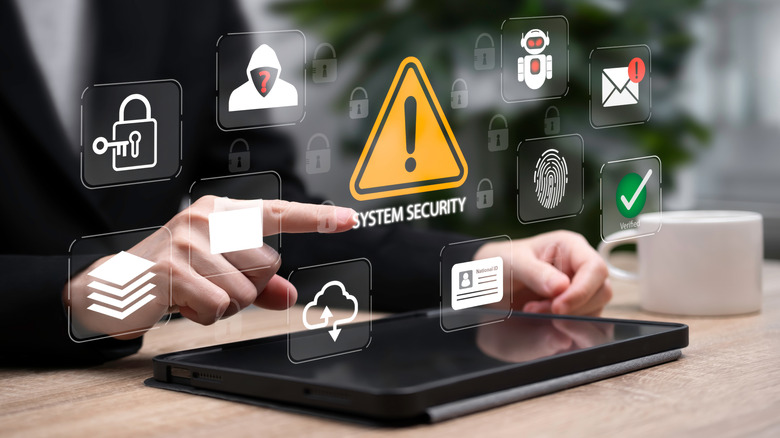 Εικονίδια ασφαλείας και απατεώνων τοποθετημένα πάνω από ένα tablet.