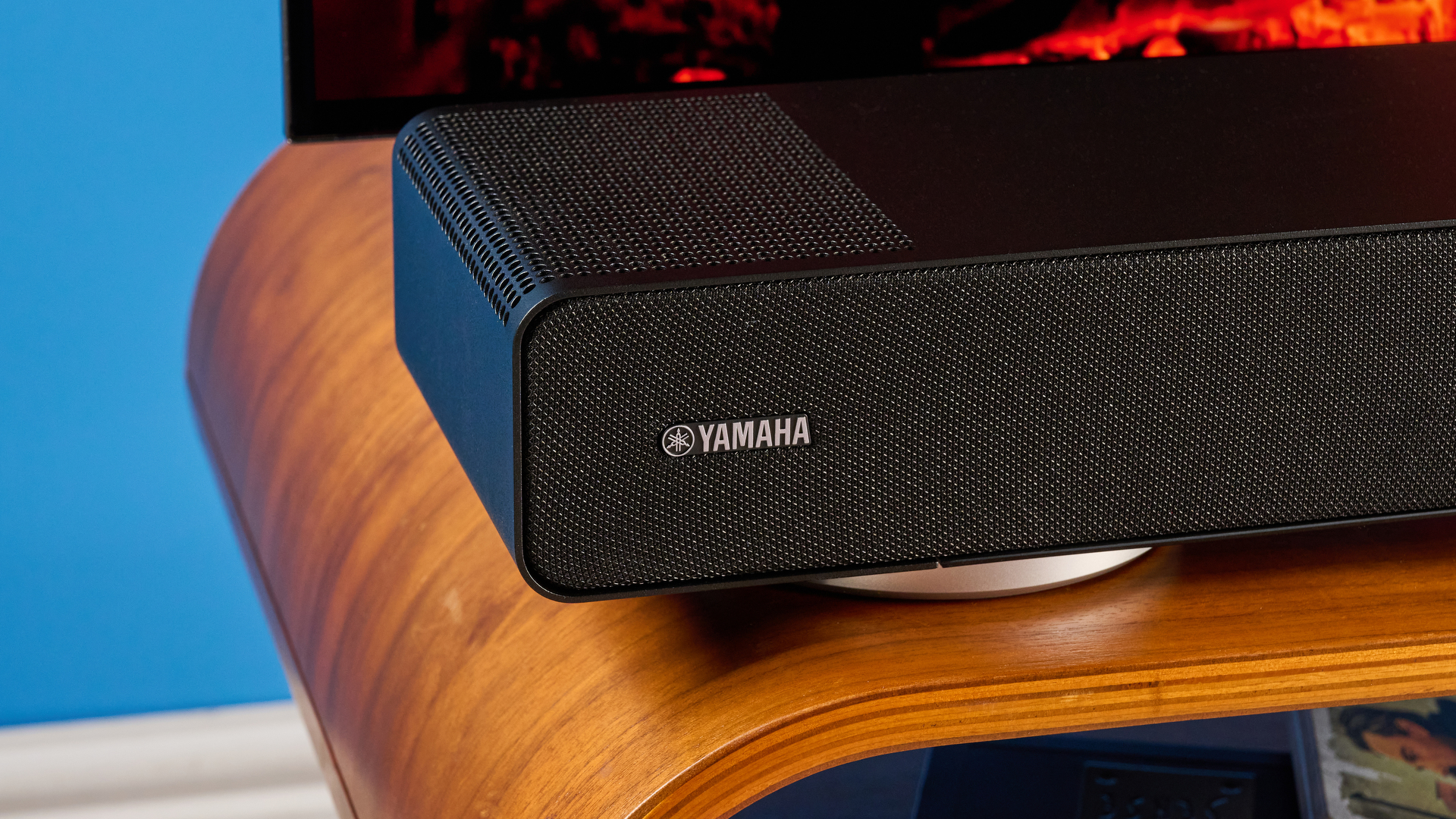 the yamaha true x surround 90a soundbar with dolby atmos, subwoofer, surround rear wireless speakers, and a 5.1.4 channel configuration photographed alongside a TV