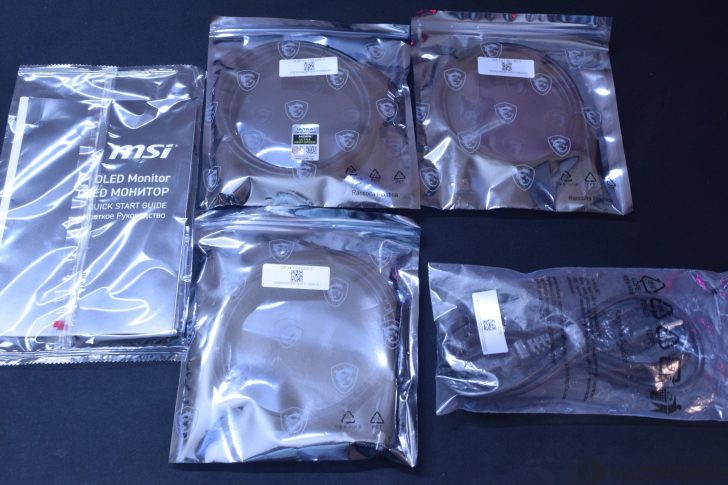 MSI MPG 341CQR X36 QD-OLED Gaming Monitor Review: Ultra-Wide Perfection With 360Hz MSI OLED Monitor quick start guide and multiple labeled cables are packaged in sealed bags with MSI logo branding.