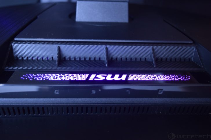 MSI MPG 341CQR X36 QD-OLED Gaming Monitor Review: Ultra-Wide Perfection With 360Hz Close-up of an MSI gaming monitor with carbon fiber accents and a glowing MSI logo.