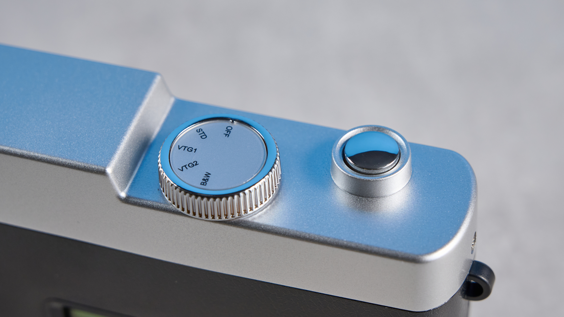 Camp Snap CS-Pro in black and silver photographed on a blue background