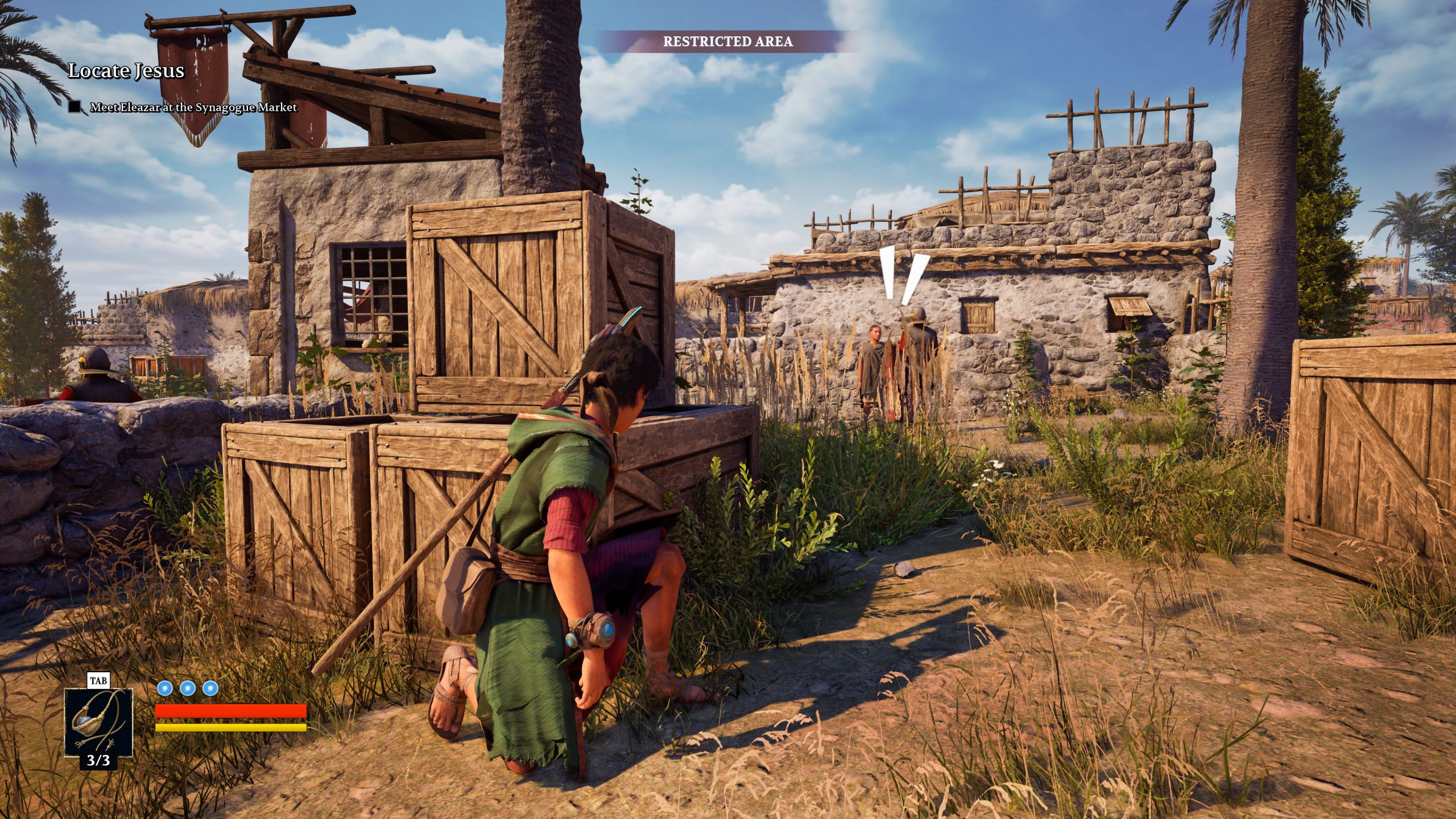 A character in the game Unrecorded is sneaking behind crates in a village setting, with the objective text 'Locate Jesus' and 'Restricted Area' at the top of the screen.
