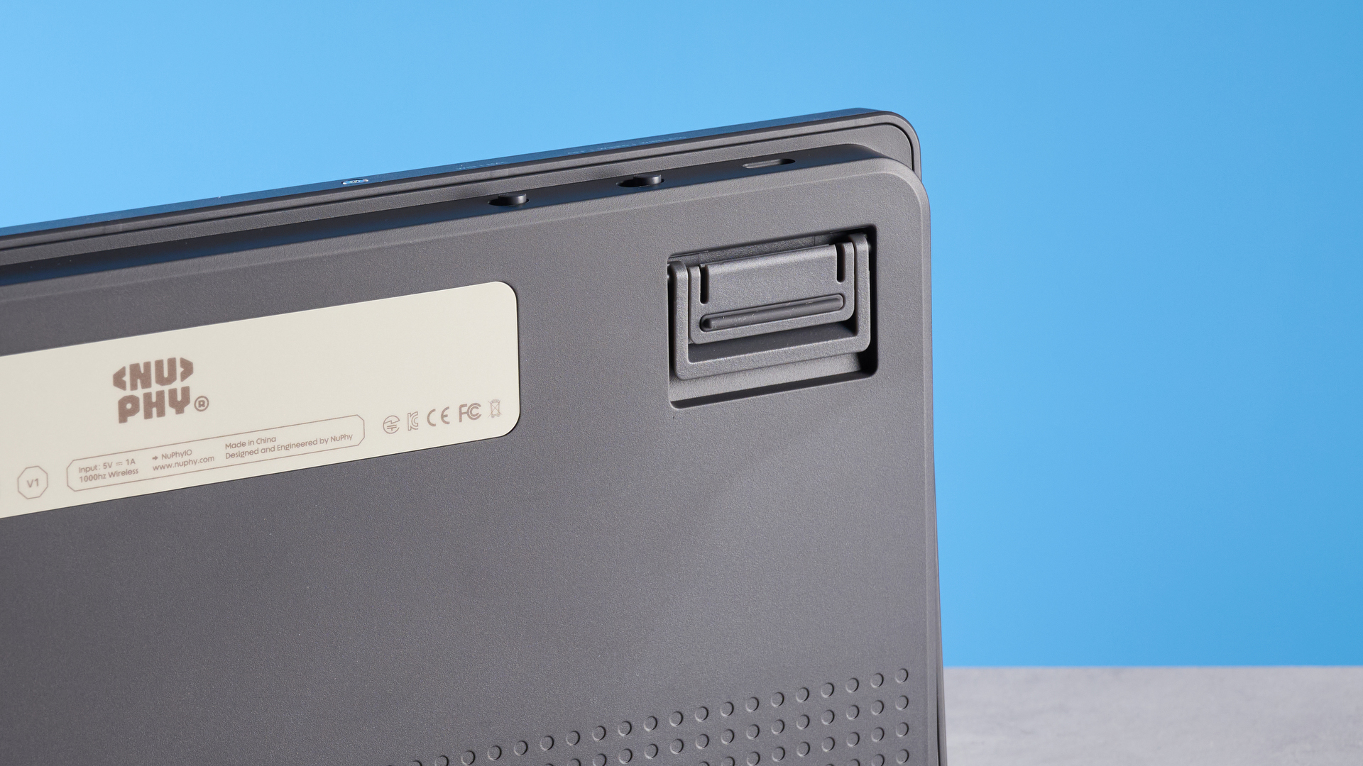 The NuPhy Node75 on a stone surface with a blue background