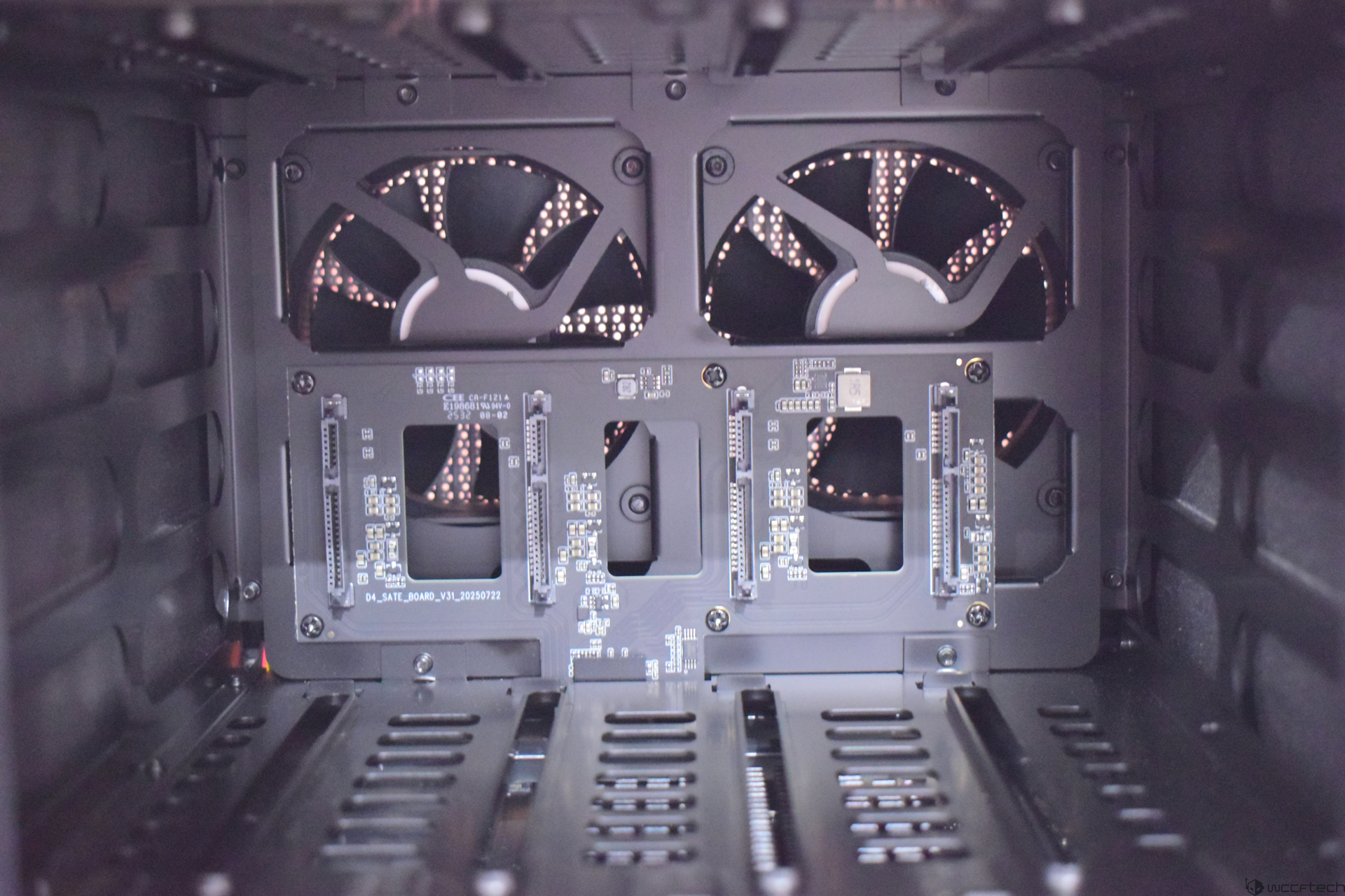 Zettlab D4 Review — A Convenient Budget AI NAS For Photographers And Content Creators The image shows an interior view of a computer case featuring two cooling fans and several unbranded PCIe slots on a panel labeled 'D4_SATE_BOARD_V31_20230722'.