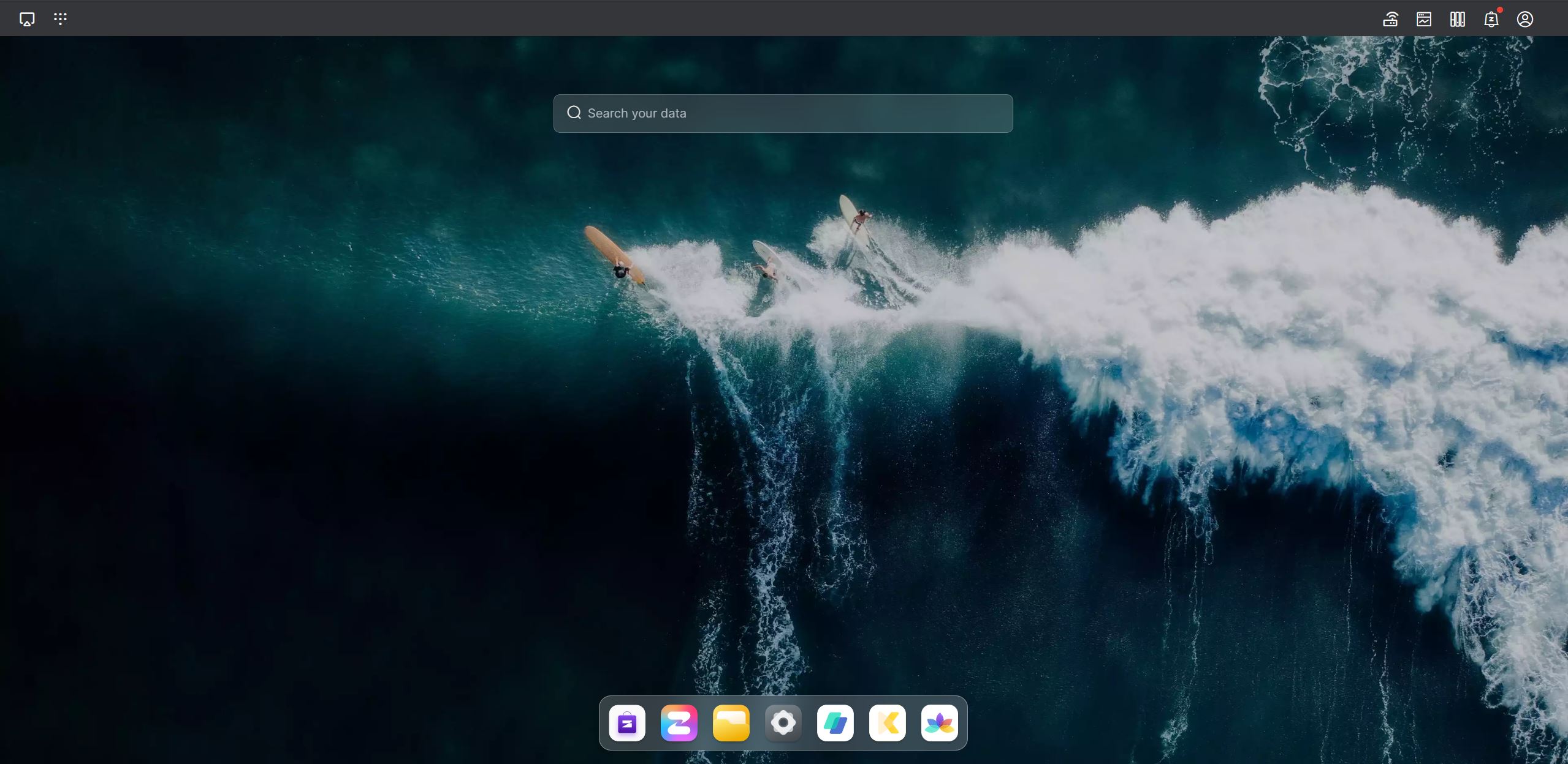 Zettlab D4 Review — A Convenient Budget AI NAS For Photographers And Content Creators A desktop screen shows a wallpaper of surfers on waves, with a search bar labeled 'Search your data' and application icons at the bottom.
