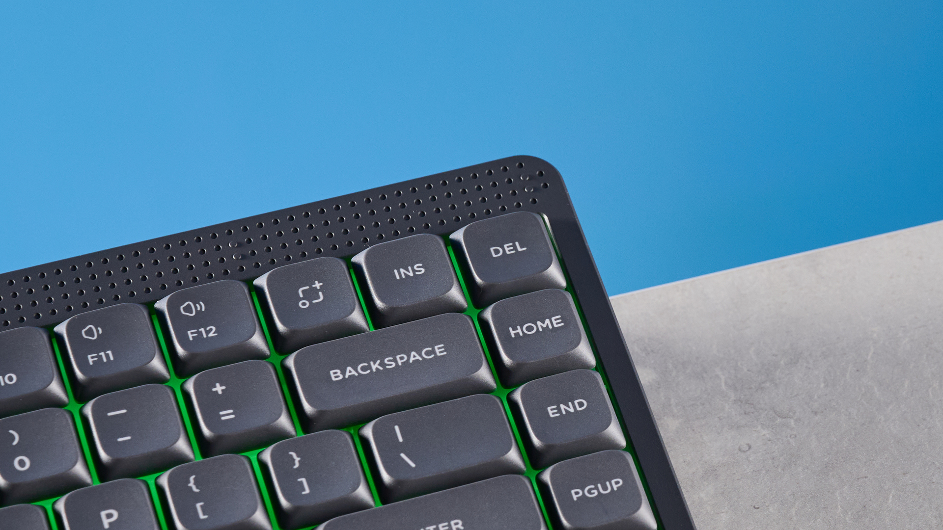 The NuPhy Node75 on a stone surface with a blue background