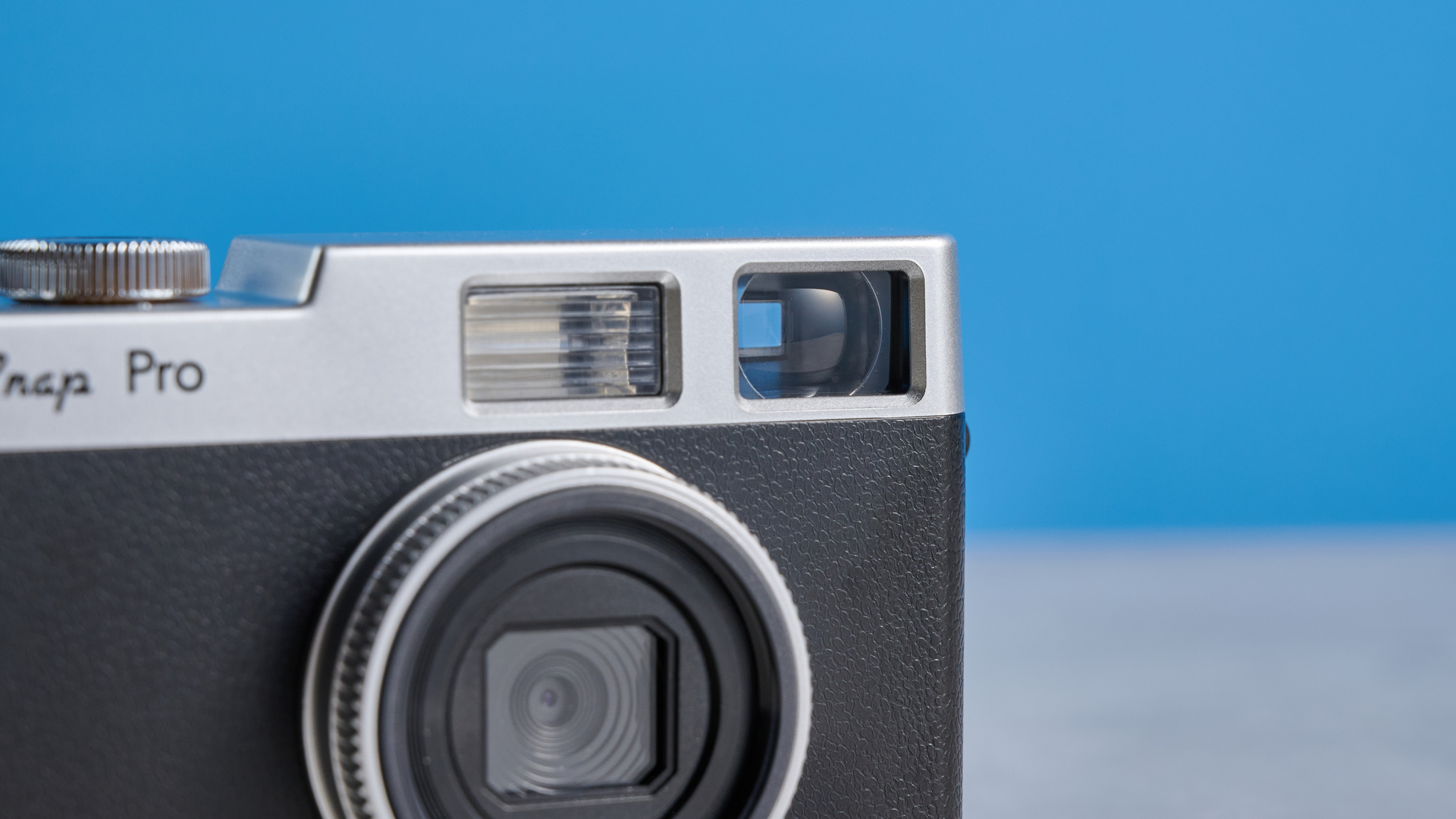 Camp Snap CS-Pro in black and silver photographed on a blue background