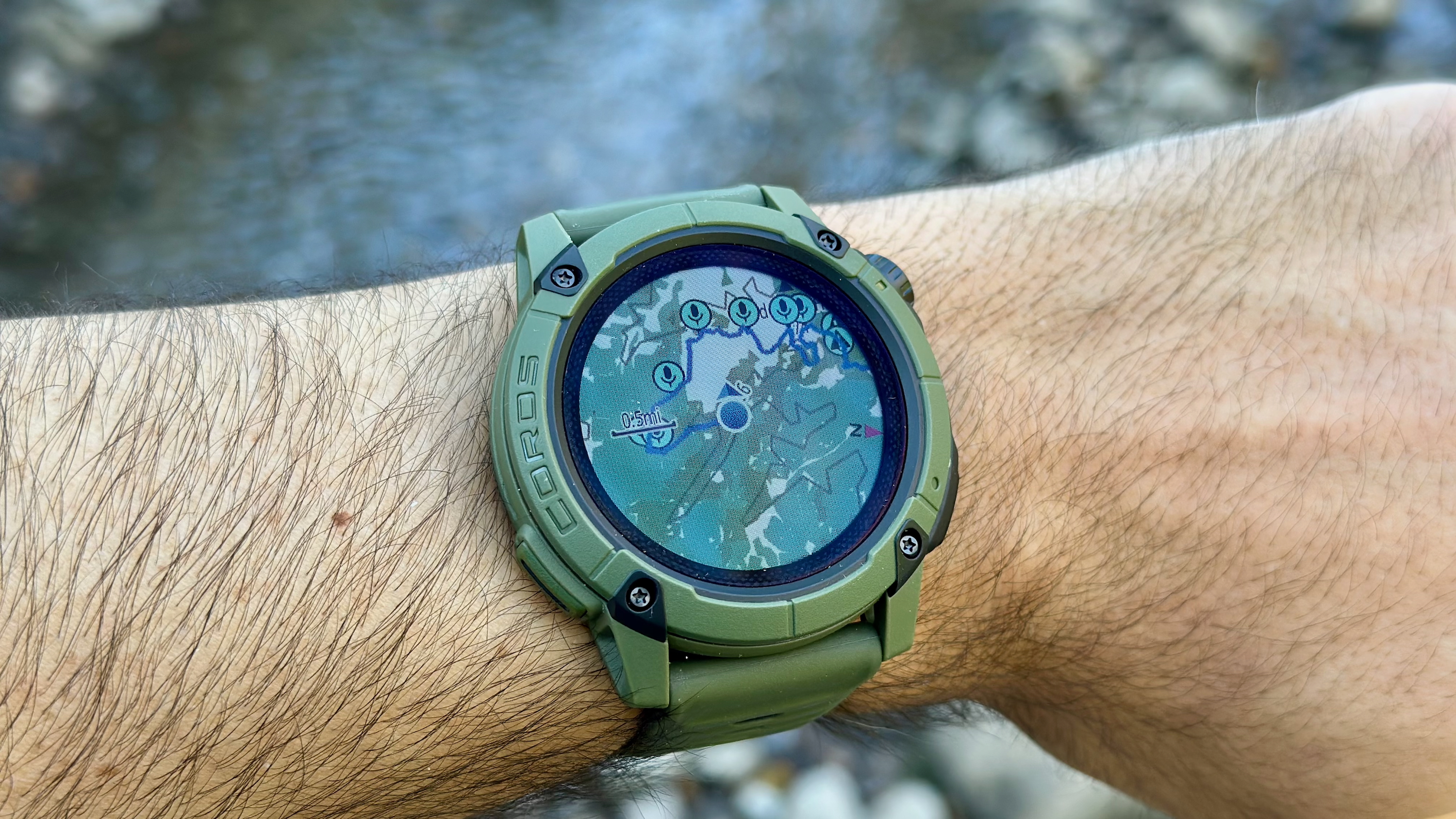 Photo of the COROS NOMAD with the map open, showing the current route path and several Voice Pin icons along it.