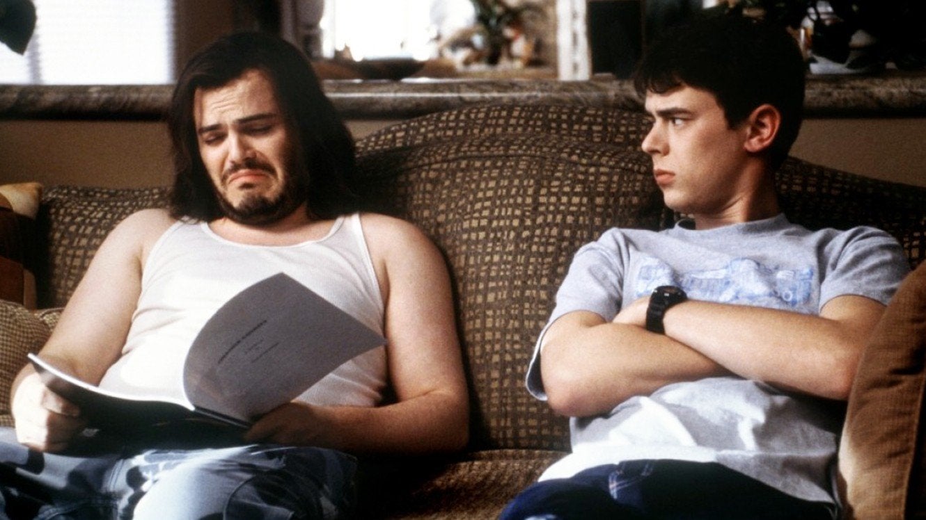Jack Black and Colin Hanks sit on a sofa